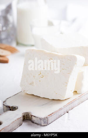 Fresh cottage cheese on rustic white wooden board, homemade organic dairy product Stock Photo