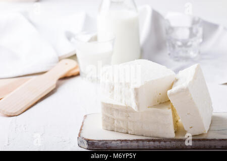 Fresh cottage cheese on rustic white wooden board, homemade organic dairy product Stock Photo