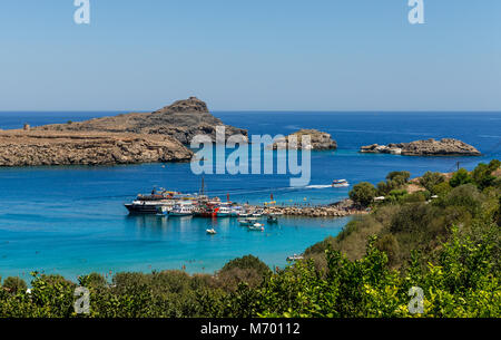A view of Lindos beach and bay from the Acropolis of Lindos. In the island of Rhodes, in Greece. Stock Photo