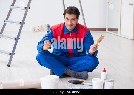 Young painter trying to match colours for painting job Stock Photo