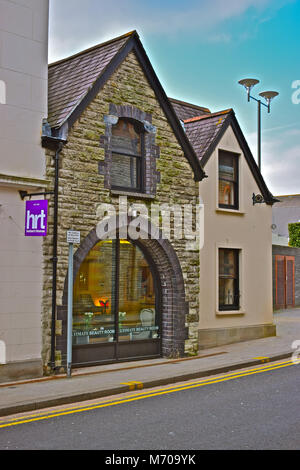 A curious small building next to the old Toll House building  Bridgend, S.Wales.It is a Grade II Listed Building-possibly an old coach house/stable. Stock Photo