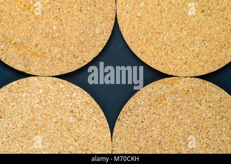 Cork drink coaster on dark blue background Stock Photo
