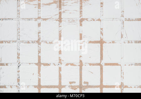 Texture of ceramic scratched tile with checkered embossing. White scratched wall background Stock Photo