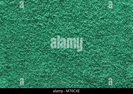 Abstract background of shaggy green carpet pile. Cloth texture with long fibers Stock Photo