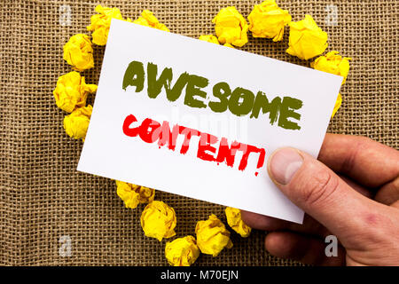 Handwritten text sign showing Awesome Content. Conceptual photo Creative Strategy Education Website Concept written Sticky Note Paper With Heart Holdi Stock Photo