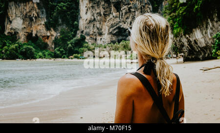 Blond beautiful Women with Sunglasses and Backpack on Raily, Hat Tom Sai Beach, Railay, Krabi Stock Photo