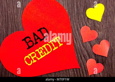 Handwriting Announcement text showing Bad Credit. Concept meaning Poor Bank Rating Score For Loan Finance written Heart Love the wooden background. Stock Photo