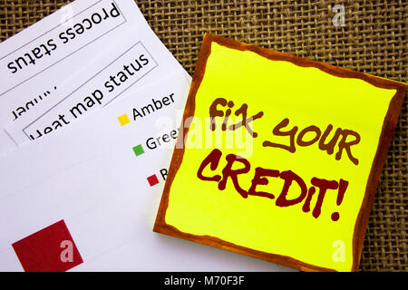 Handwritten text sign showing Fix Your Credit. Business concept for Bad Score Rating Avice Fix Improvement Repair written Sticky Note Paper with Heat  Stock Photo
