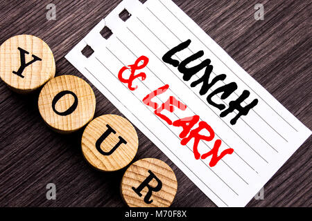 Writing text showing  Lunch And Learn. Business photo showcasing Presentation Training Board Course written tear note paper sticky note the wooden bac Stock Photo