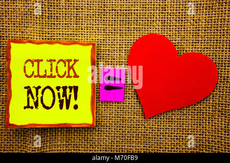 Handwriting text showing Click Now. Business concept for Sign Book Or Register Banner For Join Apply written Stiky Note Paper Meaning Love For the tex Stock Photo