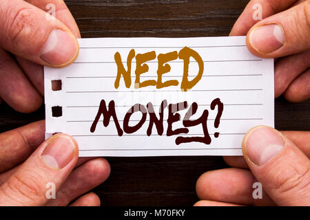 Handwritten text sign showing Need Money Question. Business concept for Economic Finance Crisis, Cash Loan Needed written Sticky Note Paper Holding Ha Stock Photo