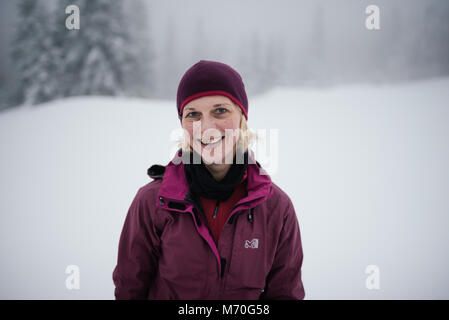 Woman hiking in the mountains in winter Stock Photo