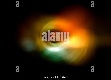 Conceptual photograph capturing colourful night lights whilst spinning and zooming during shutter release. Stock Photo