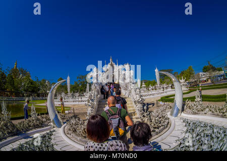 CHIANG RAI, THAILAND - FEBRUARY 01, 2018: People walking and visit the ornate white temple located in Chiang Rai northern Thailand. Wat Rong Khun, is a contemporary unconventional Buddhist temple Stock Photo