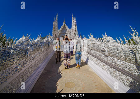 CHIANG RAI, THAILAND - FEBRUARY 01, 2018: People walking and visit the ornate white temple located in Chiang Rai northern Thailand. Wat Rong Khun, is a contemporary unconventional Buddhist temple Stock Photo