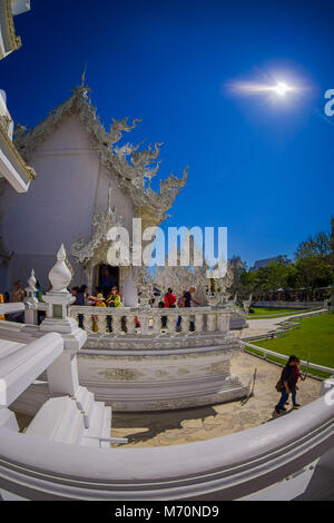 CHIANG RAI, THAILAND - FEBRUARY 01, 2018: People at beautiful ornate white temple located in Chiang Rai northern Thailand in sunny day. Wat Rong Khun, is a contemporary unconventional Buddhist temple Stock Photo