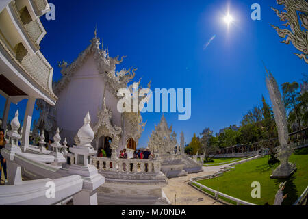 CHIANG RAI, THAILAND - FEBRUARY 01, 2018: People at beautiful ornate white temple located in Chiang Rai northern Thailand in sunny day. Wat Rong Khun, is a contemporary unconventional Buddhist temple Stock Photo