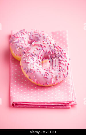 Two pink donuts on pink background. Stock Photo