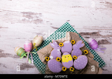 Beautiful glazed easter gingerbread cookies on wooden table. Rabbits and eggs. Greeting card. View from above.Copy space. Stock Photo