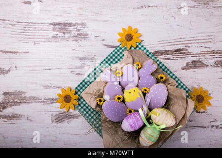 Beautiful glazed easter gingerbread cookies on wooden table. Rabbits and eggs. Greeting card. View from above.Copy space. Stock Photo