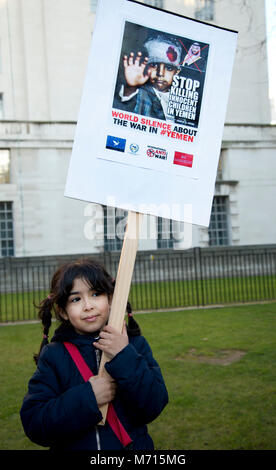 London, UK. March 7th 2018. Protest in Whitehall (opposite Downing Street) against the visit  of Crown Prince Mohammed bin Salman of Saudi Arabia, because of human rights abuses and the bombing in Yemen. Six year old Fatima with a placard saying 'Stop killing innocent children in Yemen'. Credit: Jenny Matthews/Alamy Live News Stock Photo