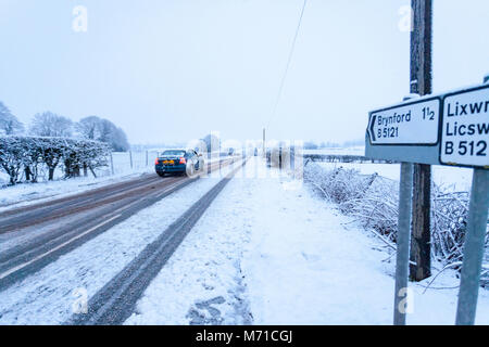 Flintshire, Wales, 8th March 2018. UK Weather. After a week of heavy snowfall and freezing temperatures further snow has fallen in some parts of the UK including Flintshire, with a Met Office Yellow warning in place for snow with heavy snowfall in the area. A driver tackling the hazardous road conditions due the heavy snow in the village of Lixwm, Flintshire Stock Photo