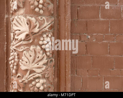 Stucco brick wall closeup with decorative ornament Stock Photo
