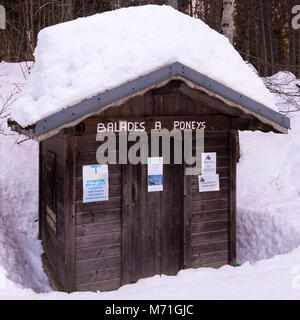 Deep Snow Covers The Roof of a Cabin on a Trail at Lac de Montriond near Morzine Haute Savoie Portes du Soleil France Stock Photo