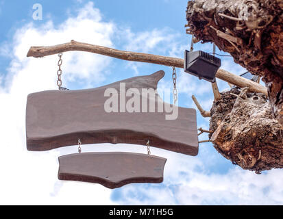wood sign on tree in the blue sky and clouds background Stock Photo