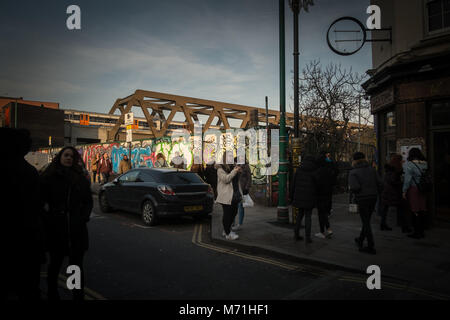 Brick Lane in London's fashionable Shoreditch region attracts tourists from the world over. Stock Photo