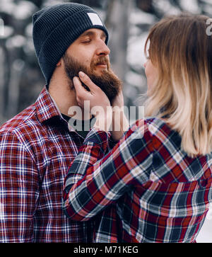 Portrait of a young couple in checkered shirts outdoor. Stock Photo