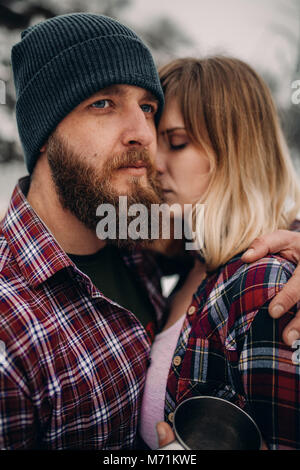 Portrait of a young couple in checkered shirts outdoor. Stock Photo