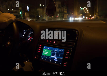 Driving car with google maps gps on dashboard (Lisbon, Portugal) Stock Photo