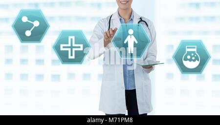 Female doctor holding tablet with medical interface hexagon icons Stock Photo