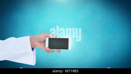 Male doctor holding phone with medical interface hexagon icons Stock Photo