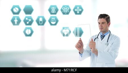 Male doctor holding tablet with medical interface hexagon icons Stock Photo