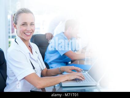 Female doctor working on laptop Stock Photo