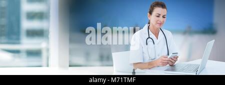 Female doctor using phone Stock Photo