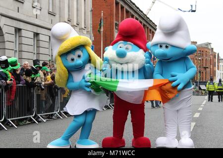 Smurfs costume character pose with Irish flag on St. Patrick's Day in Dublin. Stock Photo