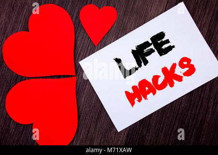 Writing text showing  Life Hacks. Concept meaning Solution Hacking Hack Trick To Help Efficiency written on notobook paper note on  wooden background  Stock Photo