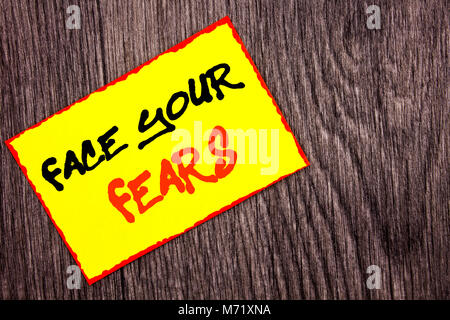 Conceptual hand writing text showing Face Your Fears. Concept meaning Challenge Fear Fourage Confidence Brave Bravery written Yellow Sticky Note Paper Stock Photo