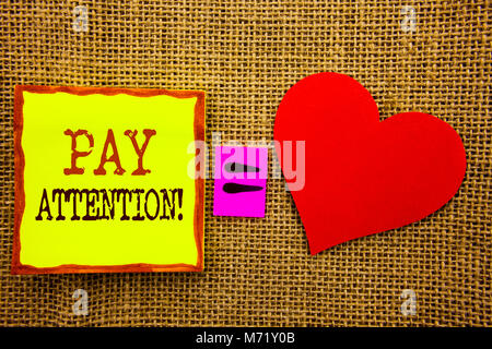 Handwriting text showing Pay Attention. Business concept for Be Careful Beware Mindful Alarm written Stiky Note Paper Meaning Love For the textured ba Stock Photo