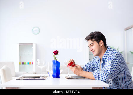 Man alone preparing for romantic date with his sweetheart Stock Photo