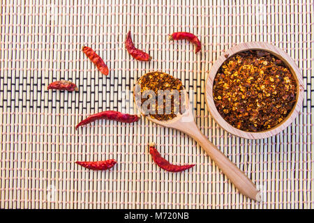 Spiced cayenne pepper in wooden bowl. Top view Stock Photo