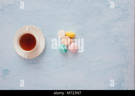 Sweet dessert. Colorful macarons on table in morning. Stock Photo