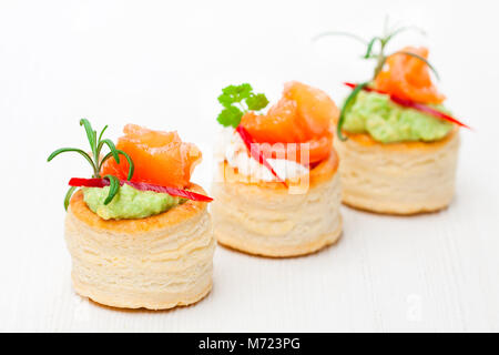 salted  puff pastry stuffed with cream cheese and smoked salmon on white background Stock Photo