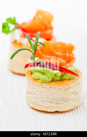 salted  puff pastry stuffed with cream cheese and smoked salmon on white background Stock Photo
