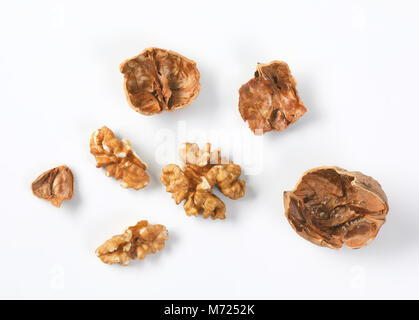 walnut kernels and shells on white background Stock Photo