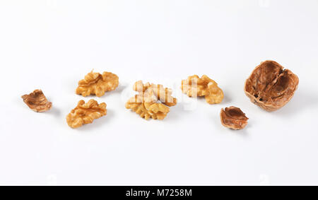 walnut kernels and shells on white background Stock Photo