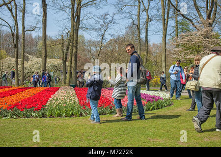 KEUKENHOF, LISSE, NETHERLANDS-APRIL 24, 2015:Tourists enjoying the colorful flowers at the Keukenhof gardens in the Netherlands Stock Photo